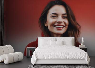 A lovely portrait wallpaper of a smiling woman in a red sweater with an abstract touch showing genuine joy, on red background isolated Wall mural