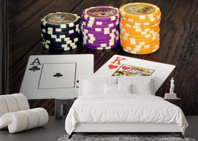 Playing cards and poker chips on a wooden table. Stack of chips for poker. Wall mural