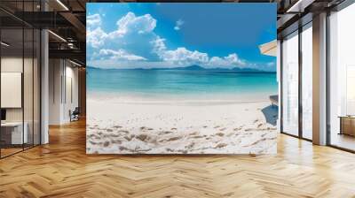 A panoramic view of the white sandy beach with two wooden sunbeds under an umbrella, overlooking clear blue water and sky. The composition is wide-angle, showcasing vastness Wall mural