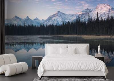 Almost nearly perfect reflection of the Rocky mountains in the Bow River. Near Canmore, Alberta Canada. Winter season is coming. Bear country. Beautiful landscape background concept. Wall mural