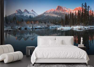 Almost nearly perfect reflection of the Three Sisters Peaks in the Bow River. Near Canmore, Alberta Canada. Winter season is coming. Bear country. Beautiful landscape background concept. Wall mural