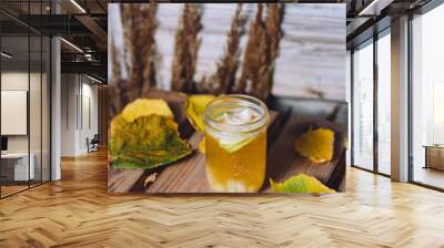 Vertical shot of a glass of hot mulled pear drink with coconut pieces Wall mural