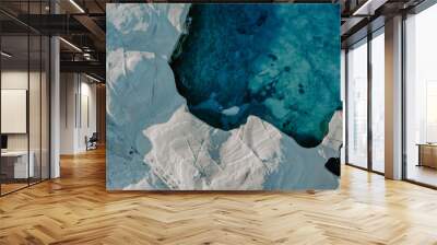 Drone aerial view of white rock formations and cliffs surrounded by turquoise waters of Aegean Sea in the Sarakiniko Beach in Milos Island Greece Wall mural