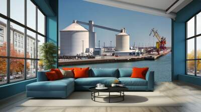 Two industrial silos with harbour cranes in the background at the port of Calais, France Wall mural