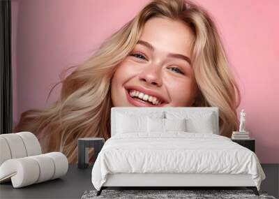 Photo of pretty woman with long blonde hair smiling, on pastel peach background, copy space concept for beauty and spa advertising banner or card template Wall mural