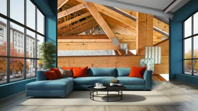 Roof trusses covered with a membrane on a detached house under construction, view from the inside, visible roof elements and truss plates. Wall mural