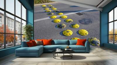 traffic element retarder yellow round points in two rows on a road asphalt lawn Wall mural