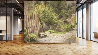 Closed wooden door fence on an agriculture field Wall mural