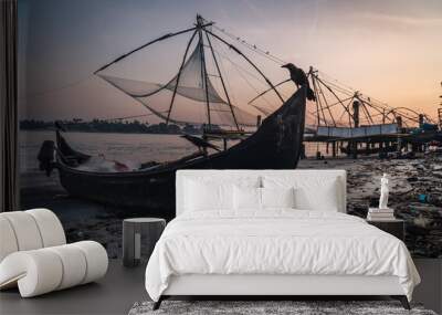 Chinese fishing nets during the Golden Hours at Fort Kochi, Kerala, India sunrise bird over the boat Wall mural