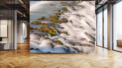 Moving Water. Close-up of moving water. Descent of a river in long exposure. Wall mural