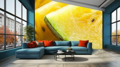 A close-up shot of vibrant yellow watermelon slices, showcasing the juicy flesh and black seeds. The image evokes a sense of freshness, summer, and sweet indulgence. Wall mural