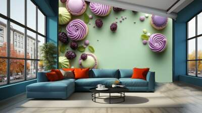 A collection of sweet treats with purple and green frosting, arranged on a green background. Concept of celebration, indulgence, and deliciousness. Wall mural