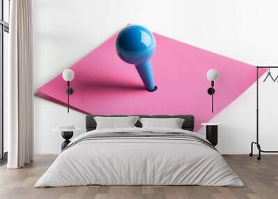 A pink sticky note with a large blue push pin stuck through the center. The push pin is partially submerged in the note, creating a visual metaphor for attention, focus, and importance. The bright col Wall mural