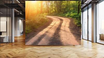 A winding dirt road through a lush green forest, bathed in warm sunlight. The path symbolizes the journey of life, with two options to choose from, each leading to an unknown destination. The sun's ra Wall mural