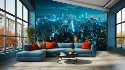 Aerial view of a futuristic smart city at night,with a glowing skyline and dynamic data streams illuminating the urban landscape. The image depicts a technologically advanced. - Aerial view of a futur Wall mural