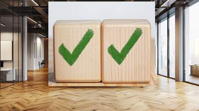 Two wooden cubes with green check marks symbolizing success, completion, achievement, agreement, and confirmation. Wall mural