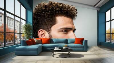 Man with curly hair studio photo Wall mural