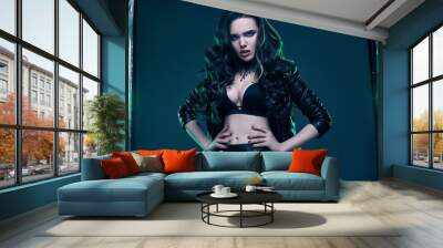 Young sexy girl with long hair in leather jacket Wall mural