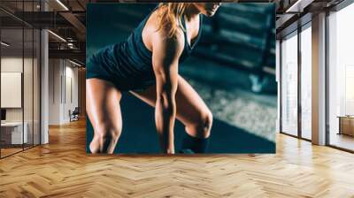 Cross training. Sporty woman exercising at the gym Wall mural