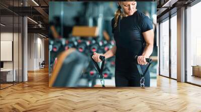 Female athlete exercising in the gym Wall mural