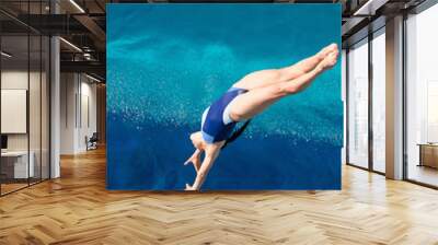 Female diving. Lady diver in the air above the swimming pool Wall mural