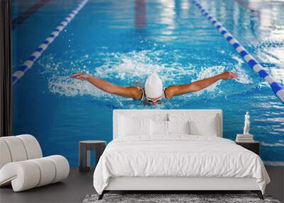 Female swimmer on training in the swimming pool Wall mural