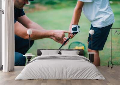 Golf Instructor adjusting young boy’s grip Wall mural