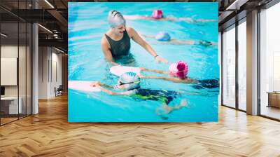 Kids having a race in swimming class Wall mural