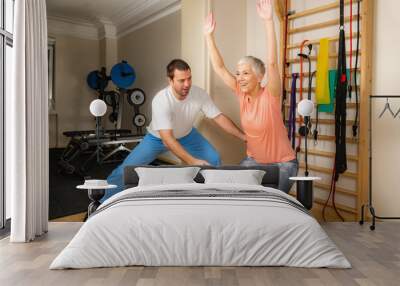 Male Trainer With Senior Woman in the Gym Wall mural