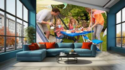 Family Enjoying Meal Outside Tent On Camping Holiday Wall mural