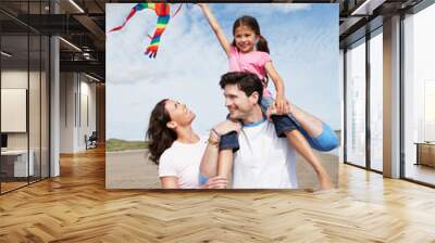 Family Having Fun Flying Kite On Beach Holiday Wall mural