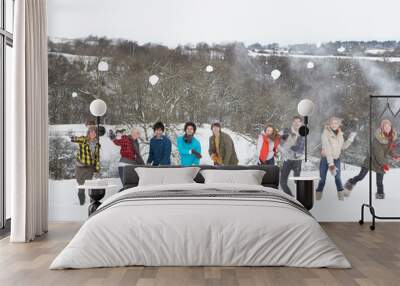 group of teenage friends having fun in snowy landscape Wall mural