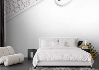 top view of modern white office desk with computer keyboard, blank notebook page and other equipment on white background. Workspace concept, workspace management style, business design space with copy Wall mural