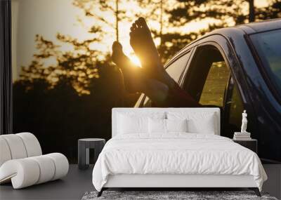 Two feet of the ground, young woman in the car barefooted Wall mural