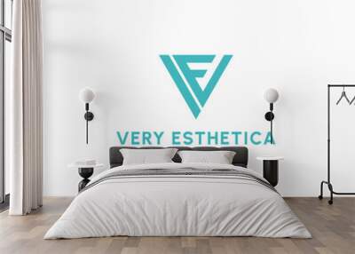 Abstract initial letter VE or EV logo in blue color isolated in white background applied for medical esthetics office logo also suitable for the brands or companies have initial name EV or VE. Wall mural