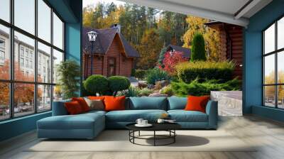 Panoramic view of a rural country house made of wooden beams and ornamental plants near a coniferous autumn forest. Wall mural