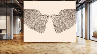 Two spread wings of an angel made of feathers isolated on a beige background. Wall mural