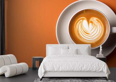 Close-up of freshly brewed latte in coffee cup on orange background Wall mural