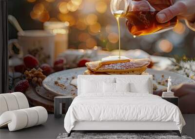 A person pours honey on delicious pancakes. Wall mural