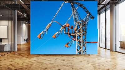 Electric pole with high voltage cables against blue sky. Wall mural