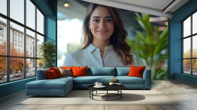 Portrait of young Hispanic professional business woman standing in office.  Wall mural