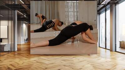 Woman does gymnastics and yoga at home, sport concept Wall mural