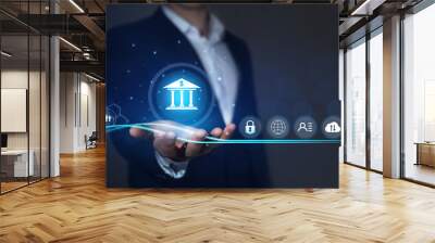  Bank safety and protection of personal and financial data. Businessman holding online banking icons and network connection icons. Digital technology business. Wall mural