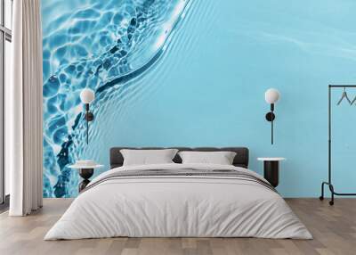 Defocused blue liquid colored clear water surface texture with splashes bubbles with copy space. Water waves in sunlight background. Trendy summer nature banner. 
 Wall mural