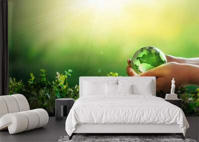 Environment day, save clean planet, ecology concept. Earth Day.Hand holding crystal earth globe.Renewable energy-based green businesses can limit climate change and global warming. Wall mural