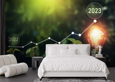 Seedlings are growing in soil with growth compared to year 2022-2023 and light bulb for innovations and ideas for the new year. Development to success in year 2023.  Wall mural