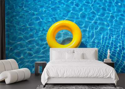 yellow swimming pool ring floating in calm blue water.  Wall mural