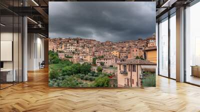 Colorful Buildings in Siena Italy with dark cloudy sky Wall mural