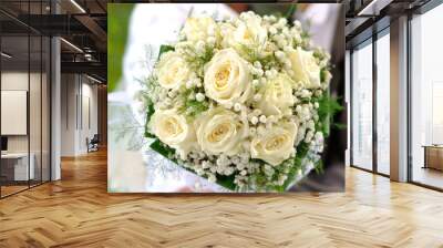 Beautiful wedding bouquet in hands of the bride and groom Wall mural