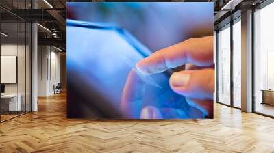 Close up of mans finger touching digital tablet screen Wall mural